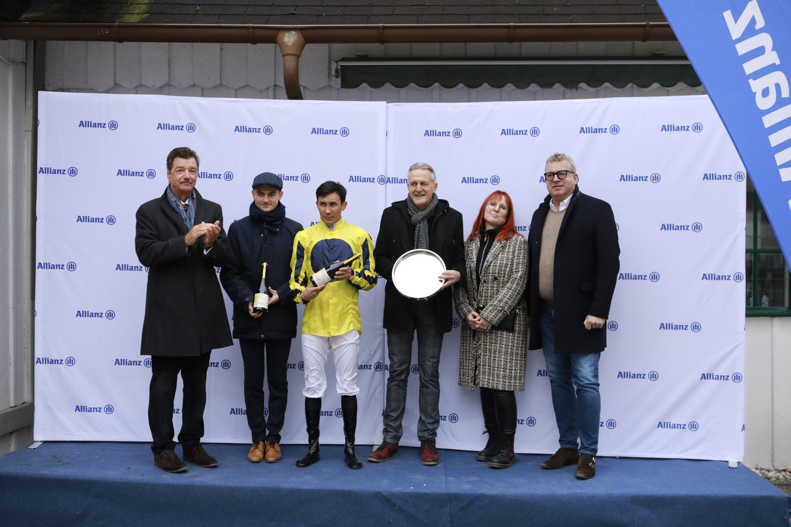 10.11.2024 - Munich; Winners presentation with Michael Motschmann (Chairman Muenchener Rennverein e.V.), Vinzenz Schiergen, member Syndicat Rapido, Nicolaus von Miltitz (Rennbahnkommentator) after winning the Preis der MIG Fonds with Wonder Boy at Munich-Racecourse/Germany. Credit: Lajos-Eric Balogh/turfstock.com