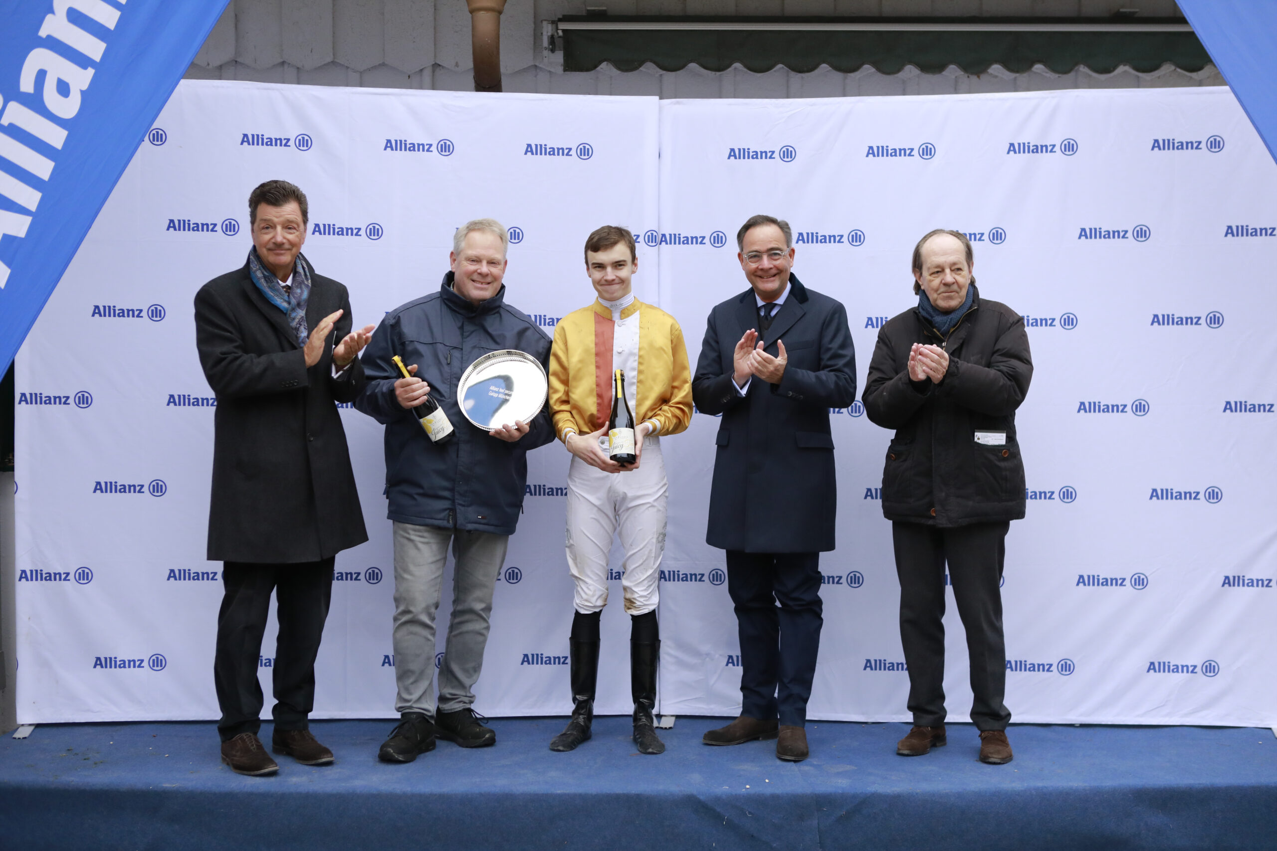 10.11.2024 - Munich; Winners presentation with Michael Motschmann (Chairman Muenchener Rennverein e.V.), Dr. Andreas Bolte, Leon Wolff, representative of the sponsor and Freiherr Dr. Georg von Gumppenberg (Chairman Muenchener Rennverein e.V.) after winning the Allianz feel secure Preis with Early Spirit at Munich-Racecourse/Germany. Credit: Lajos-Eric Balogh/turfstock.com