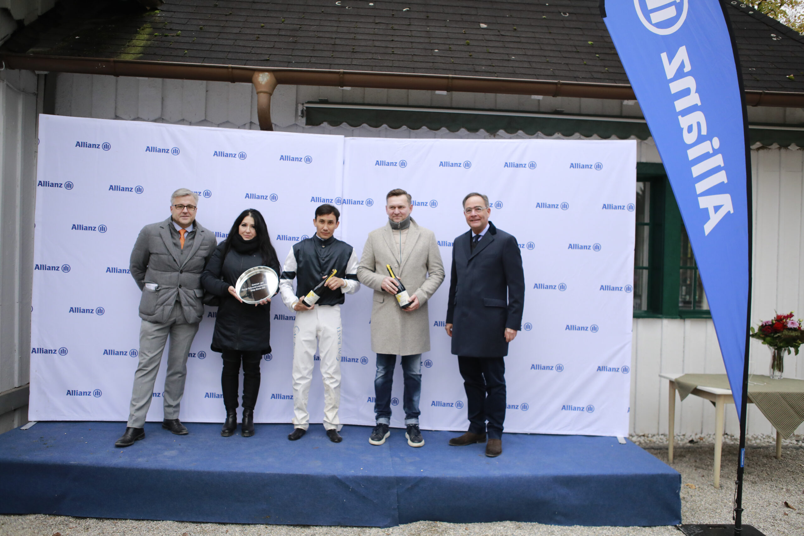 10.11.2024 - Munich; Winners presentation with Sascha Multerer (General Secretary Muenchener Rennverein e.V.), Bauyrzhan Murzabayev, Bohumil Nedorostek and representative of the sponsor after winning the Gemeinsam stark - Preis der Partnerschaft zwischen Allianz und MRV with Galvanize at Munich-Racecourse/Germany. Credit: Lajos-Eric Balogh/turfstock.com