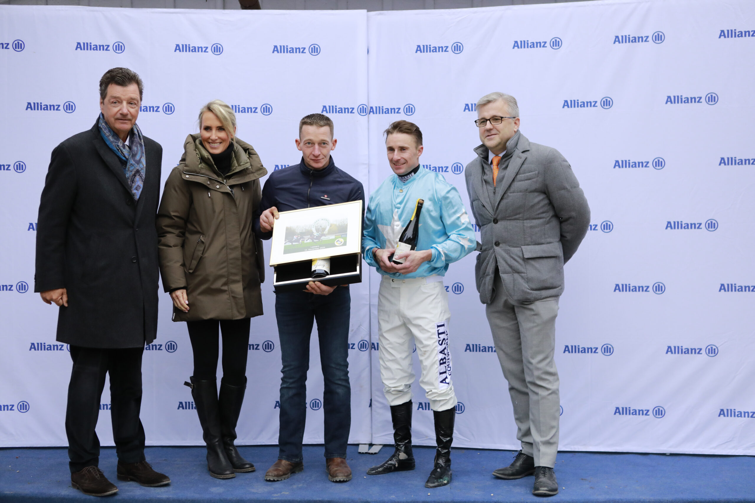 10.11.2024 - Munich; Winners presentation with Michael Motschmann (Chairman Muenchener Rennverein e.V.), representative of the sponsor, Stefan Richter, Theo Bachelot and Sascha Multerer (General Secretary Muenchener Rennverein e.V.) after winning the Preis der FUENF HOEFE with Lazzaro at Munich-Racecourse/Germany. Credit: Lajos-Eric Balogh/turfstock.com