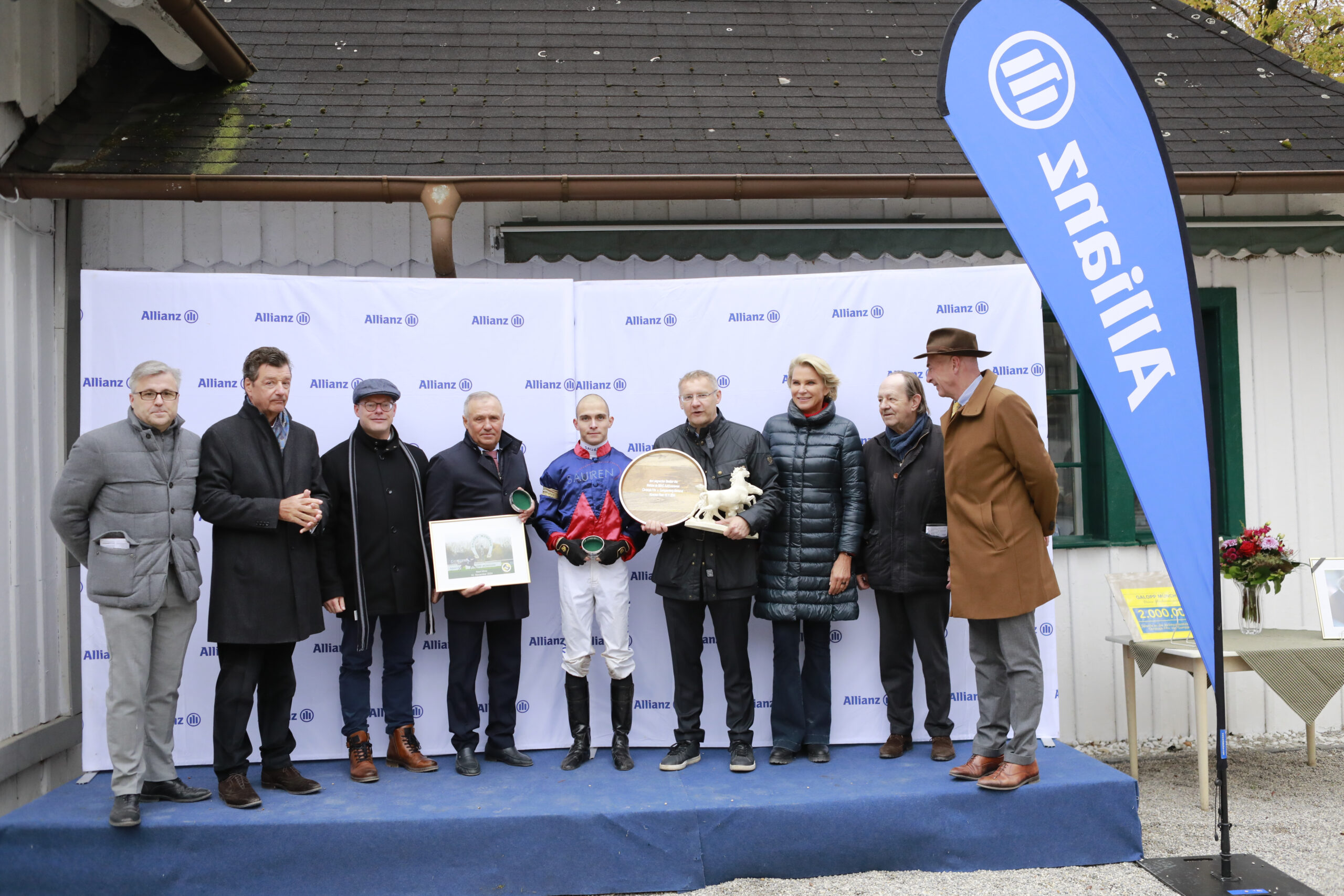 10.11.2024 - Munich; Winners presentation with Sascha Multerer (General Secretary Muenchener Rennverein e.V.), Michael Motschmann (Chairman Muenchener Rennverein e.V.), Klaus Eulenberger (BBAG Baden-Badener Auktionsgesellschaft), Waldemar Hickst, Thore Hammer-Hansen, Eckhard Sauren (CEO SAUREN Finanzdienstleistungen GmbH and Co. KG and President Cologne Racecourse 1897 e.V.), Stephanie Graefin von Pfuel (Vice-president Muenchener Rennverein e.V.), Freiherr Dr. Georg von Gumppenberg (Chairman Muenchener Rennverein e.V.) and Christian Freiherr von der Recke after winning the World Pool BBAG Auktionsrennen - Christoph Frhr. v. Gumppenberg-Memorial with Next Mine at Munich-Racecourse/Germany. Credit: Lajos-Eric Balogh/turfstock.com