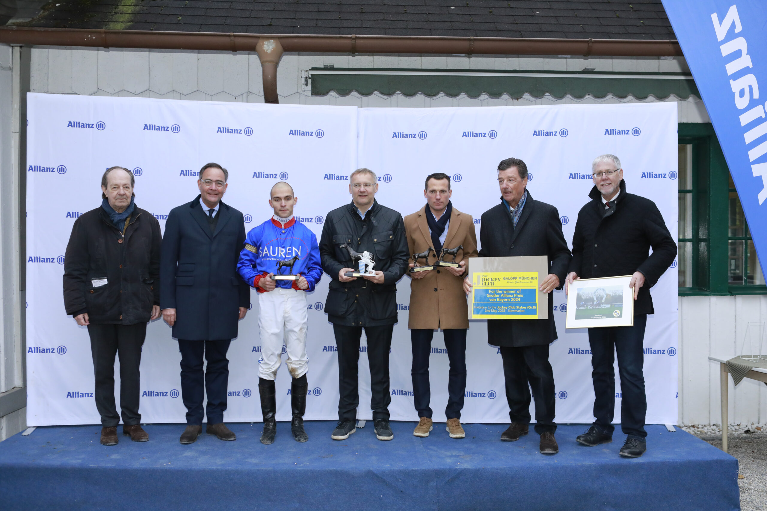 10.11.2024 - Munich; Winners presentation with Freiherr Dr. Georg von Gumppenberg (Chairman Muenchener Rennverein e.V.), Dr. Klaus-Peter Roehler, Thore Hammer-Hansen, Eckhard Sauren (CEO SAUREN Finanzdienstleistungen GmbH and Co. KG and President Cologne Racecourse 1897 e.V.), Henk Grewe, Michael Motschmann (Chairman Muenchener Rennverein e.V.) and Dr. Georg Beck (Bayerisches Staatsministerium für Ernährung, Landwirtschaft und Forten) after winning the Grosser Allianz Preis von Bayern (Group 1) with Assistent at Munich-Racecourse/Germany. Credit: Lajos-Eric Balogh/turfstock.com