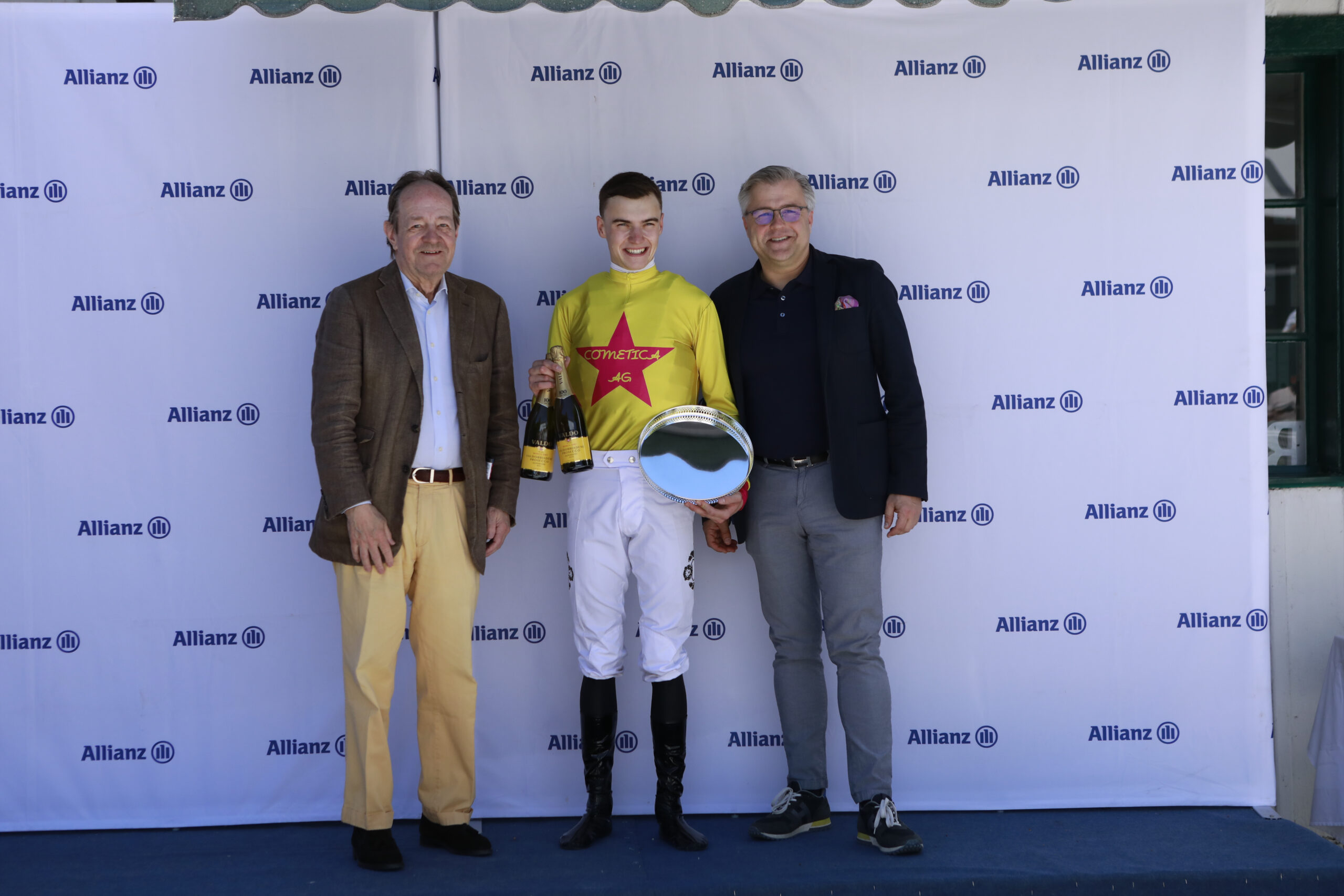 23.05.2026 - Munich; Winners presentation with Freiherr Dr. Georg von Gumppenberg (Chairman Muenchener Rennverein e.V.), Leon Wolff and Sascha Multerer (General Secretary Muenchener Rennverein e.V.) after winning the Auftakt zur V7-Wette with See Ares at Munich-Racecourse/Germany. Credit: Lajos-Eric Balogh/turfstock.com