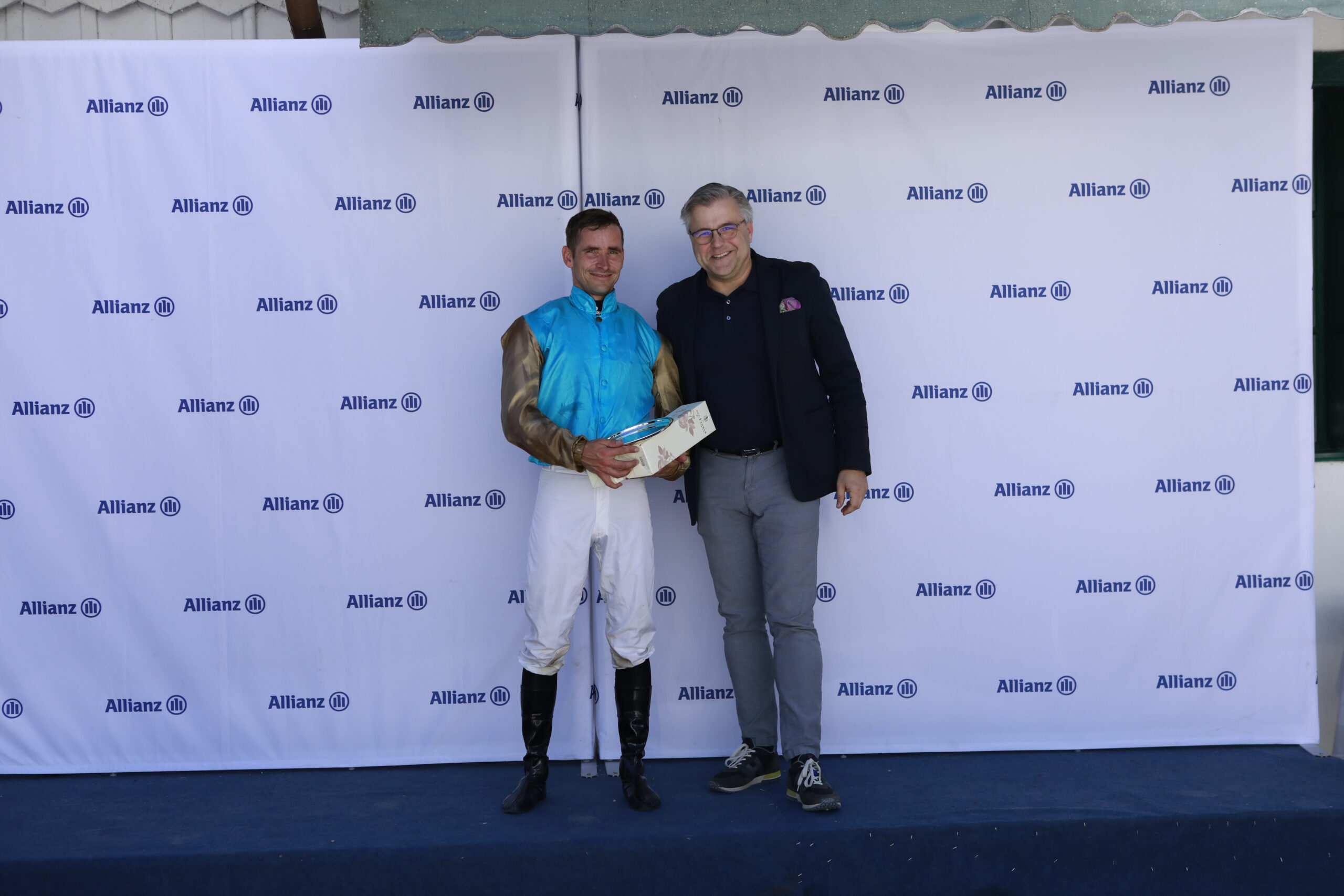 23.05.2026 - Munich; Winners presentation with Rene Piechulek, Sascha Multerer (General Secretary Muenchener Rennverein e.V.) after winning the Auftakt zur V4-Wette with Akronym at Munich-Racecourse/Germany. Credit: Lajos-Eric Balogh/turfstock.com